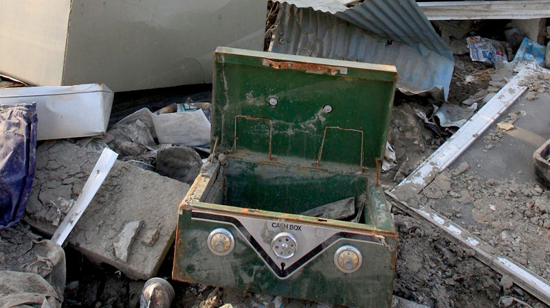 A broken cashbox sits in the debris in tsunami-hit city of Ofunato, Iwate prefecture, Japan, April 7, 2011. (AP / Lee Jin-man)