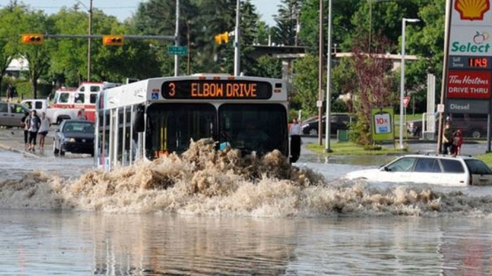A Calgary transit bus tries to navigate a main road in north Calgary on Friday, Aug. 5, 2011. (Larry MacDougal / THE CANADIAN PRESS)