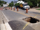 Crews work to repair a large sink hole on Riverside Drive East in Windsor, Ont., on Monday, June 24, 2013. (Chris Campbell / CTV Windsor)
