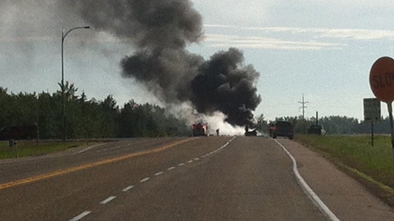 Smoke rose from the scene of a fatal collision between a tanker truck and a minivan on Hwy 63 near the Village of Boyle on Monday, June 24.