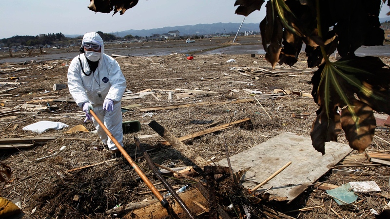 A police officer in protective suit searches for missing people in Minami Soma, Fukushima Prefecture, northeastern Japan, Wednesday, April 13, 2011. (AP / Hiro Komae)