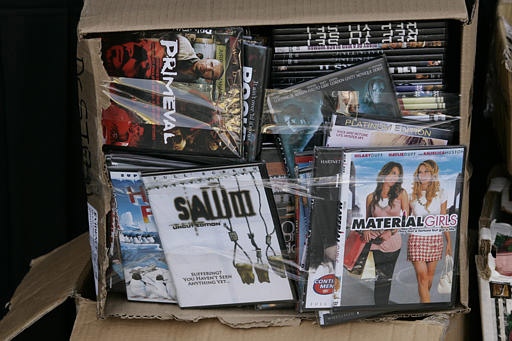 Pirated movies and music are displayed Friday, Feb. 16, 2007. (AP / Damian Dovarganes)