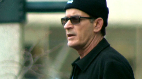Charlie Sheen gestures to his fans outside of Toronto's Ritz-Carlton hotel ahead of his awareness and fundraising walk for bipolar disorder on Friday, April 15, 2011.