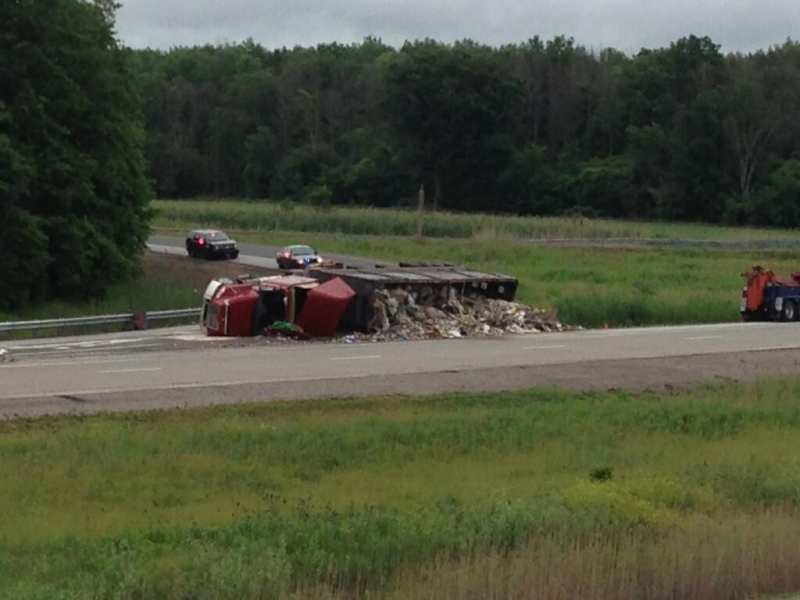 A garbage truck rollover on Highway 402 at Oil Heritage Road north of Petrolia, Ont. is seen on Friday, June 28, 2013. (Bryan Bicknell / CTV London)
