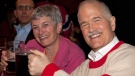 NDP Leader Jack Layton raises his mug of beer with his sister Nancy while watching the first period of the Montreal Canadiens and Boston Bruins game on television in a sports bar in Montreal, Thursday, April 14, 2011. (Jacques Boissinot / THE CANADIAN PRESS)