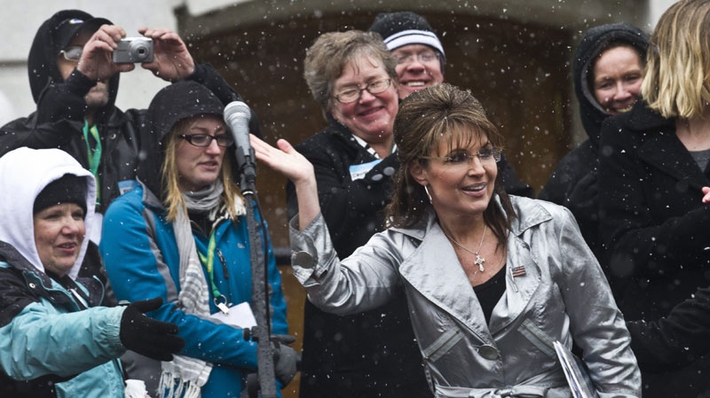 Former Alaska Gov. Sarah Palin waves to supporters after speaking at a tax day tea party rally Saturday, April 16, 2011, in Madison, Wis. (AP Photo/Morry Gash)