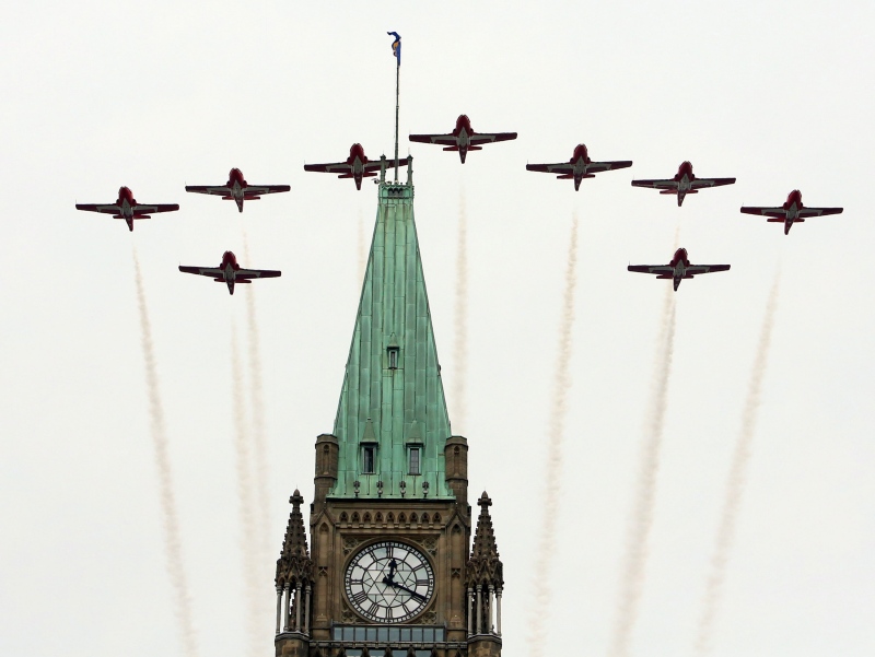 The Snowbirds Canadian aerobatic jets fly over the Peace Tower at the Canada Day celebrations on Parliament Hill, in Ottawa Monday, July, 1, 2013. (Fred Chartrand / THE CANADIAN PRESS)