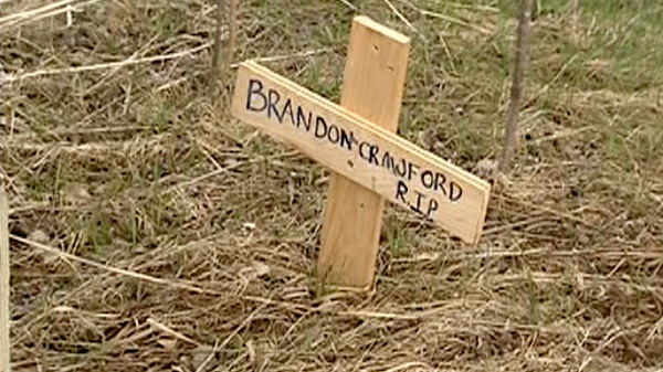 A cross for Brandon Crawford was erected on the side of Highway 148 in west Quebec. Crawford was killed in a two-vehicle crash when his car crossed into oncoming traffic, Saturday, April 16, 2011.