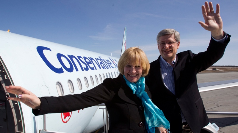 Stephen Harper and his wife Laureen wave upon arrival in Val D'Or, Quebec on Tuesday April 19, 2011. (Frank Gunn / THE CANADIAN PRESS)