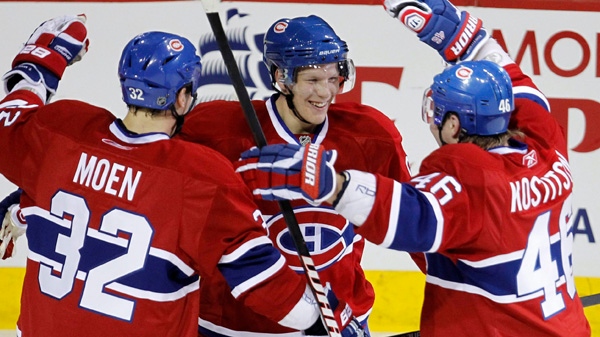 Montreal Canadiens' Lars Eller, centre, celebrates his second goal with teammates Travis Moen, left, and Andrei Kostitsyn as they face the Boston Bruins during first period NHL action Tuesday, March 8, 2011 in Montreal. THE CANADIAN PRESS/Paul Chiasson