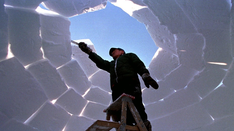 An Inuit man works on a traditional igloo Tuesday, March 23, 1999 in preparation for the celebrations of Nunavut Day in the eastern Arctic community of Iqaluit, NWT. A new survey of southern Canadians found 69 per cent believe northerners still live in igloos.