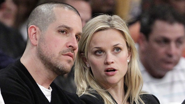 In this Jan. 4, 2011 file photo, actress Reese Witherspoon and her then-fiance, Jim Toth, watch an NBA basketball game between Los Angeles Lakers and the Detroit Pistons in Los Angeles. (AP Photo/Jae C. Hong, File)