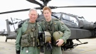 Prince Harry with his father, Prince Charales, standing in front of an Apache Helicopter at Middle Wallop, England after Prince Charles was invited by the Army Aviation Centre to meet students on the Apache Conversion Course. (Richard Dawson / Ministry of Defence) 