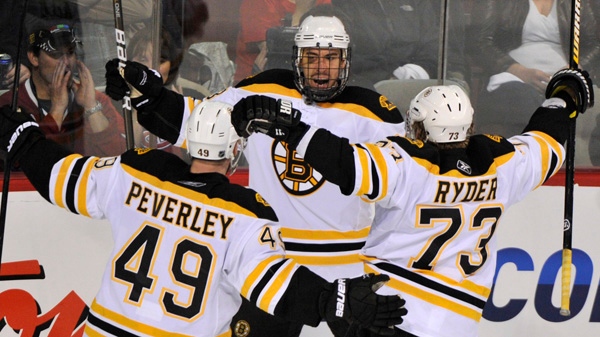 Boston Bruins' Chris Kelly celebrates his goal against the Montreal Canadiens with teammates Rich Peverley and Michael Ryder during third period of Game 4 NHL Stanley Cup playoff hockey action Thursday, April 21, 2011 in Montreal. THE CANADIAN PRESS/Paul Chiasson