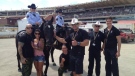 Members of The SkyHawks pose with mounted officials in the Calgary Stampede infield following an early 2013 performance (Courtesy: Facebook)