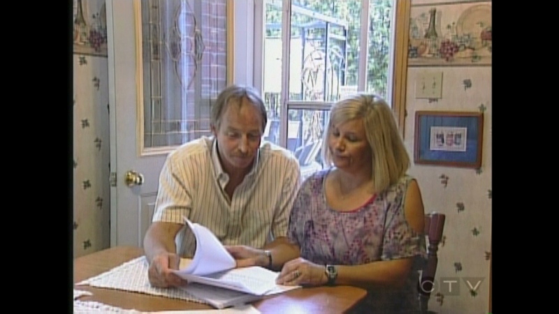 Michelle and Damian Smith look over a new report on the chemicals in their home in London, Ont. on Monday, July 8, 2013.