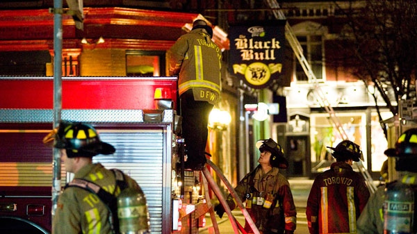 Toronto Fire Fighters are seen at the scene of a fire at the Black Bull Restaurant and Bar on Queen St. West and John Street in Toronto on Thursday, April 21, 2011. (Aaron Vincent Elkaim / THE CANADIAN PRESS)