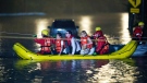 Stranded passengers are rescued from a flooded GO Train in Toronto, late Monday, July 8, 2013. (Frank Gunn / THE CANADIAN PRESS)
