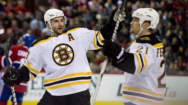 Boston Bruins' Andrew Ference (21) celebrates with teammate Patrice Bergeron, after scoring against the Montreal Canadiens during second period Game 4 NHL Stanley Cup playoff hockey action in Montreal, Thursday, April 21, 2011. (THE CANADIAN PRESS/Graham Hughes)