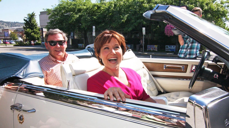 B.C. Premier Christy Clark and former MLA Ben Stewart, left, leave a coffee shop after making a brief stop as she campaigns in Kelowna, B.C., on Wednesday, July 10, 2013. (THE CANADIAN PRESS/Chris Stanford)