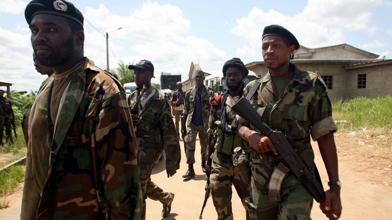 Soldiers from the 'Invisible Commandos', loyal to Ibrahim Coulibaly, walk in the PK-18 area of the Abobo neighborhood, in Abidjan, Ivory Coast, Monday, April 25, 2011.  (AP / Emanuel Ekra)