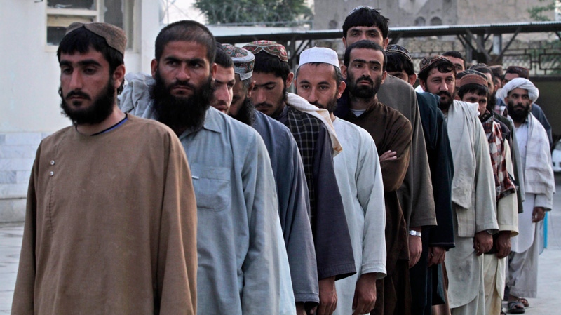 Recaptured Afghan prisoners line up in jail in Kandahar, Afghanistan, Tuesday, April 26, 2011. (AP / Allauddin Khan)