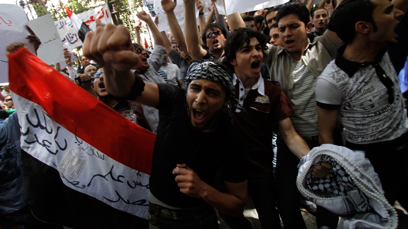 Syrian protesters chant angry slogans as they protest against the ongoing violence in Syria in front of the Syrian embassy in Cairo, Egypt, Tuesday, April 26, 2011. (AP / Khalil Hamra)
