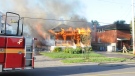 Flames tear through a house in the 200 Block of Donald St. on Monday, July 15, 2013.
