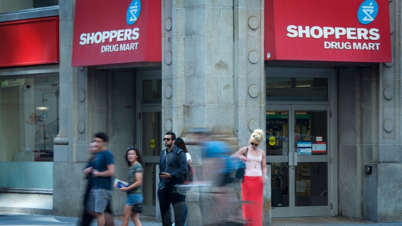 People pass by a Shoppers Drug Mart in downtown Toronto on Monday, July 15, 2013. (Graeme Roy / THE CANADIAN PRESS)