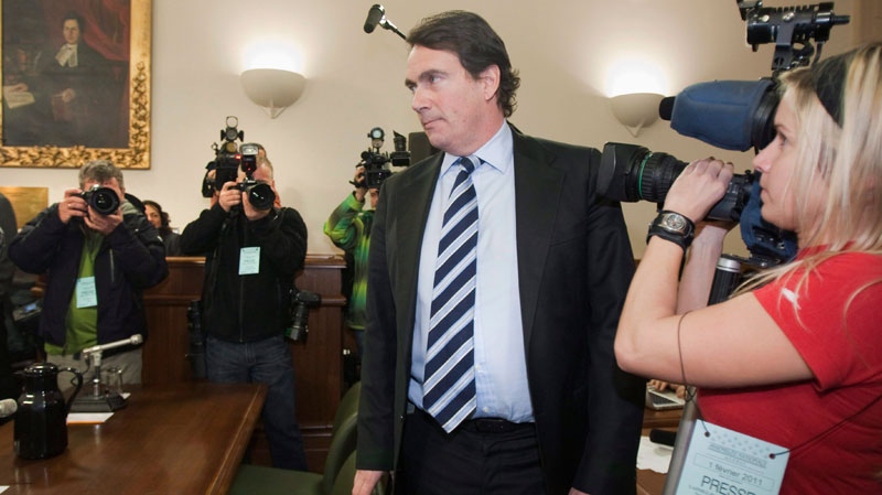 Pierre-Karl Peladeau, president of Quebecor, walks by media people to testify at a legislature committee on Labour 2011 at the legislature in Quebec City, Tuesday, February 1. (Jacques Boissinot / THE CANADIAN PRESS)