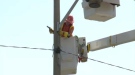 A Kitchener-Wilmot Hydro employee works on a power line on Strasburg Road in Kitchener on Tuesday, July 16, 2013.