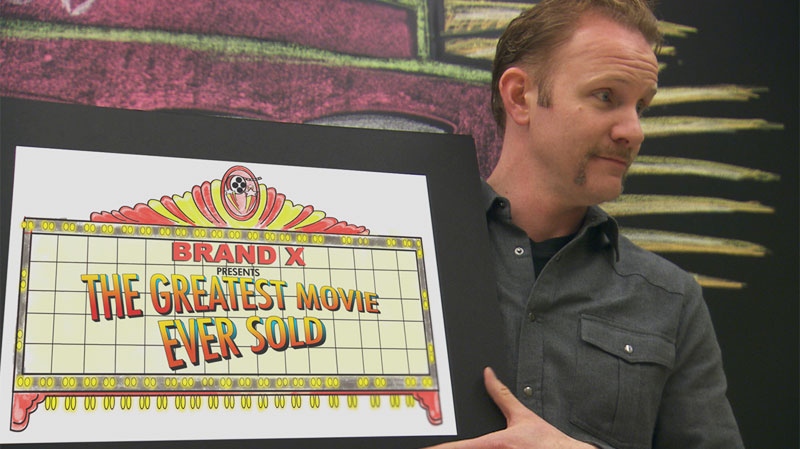 Director Morgan Spurlock holds a sign for his documentary 'Pom Wonderful Presents: The Greatest Story Ever Sold.'(Daniel Marracino / courtesy of Sony Pictures Classics)