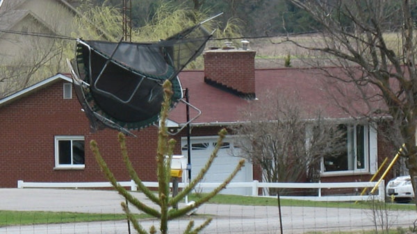 A trampoline rests over a hydro line in Pakenham, west of Ottawa, Thursday, April 28, 2011. Viewer photo submitted by: Darlene Clevenger