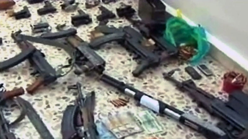 In this photo released by the Syrian official news agency SANA, weapons that were confiscated by armed forces from what they say terrorist groups in the southern province of Daraa, Syria, Wednesday, April 27, 2011. (AP / SANA) 