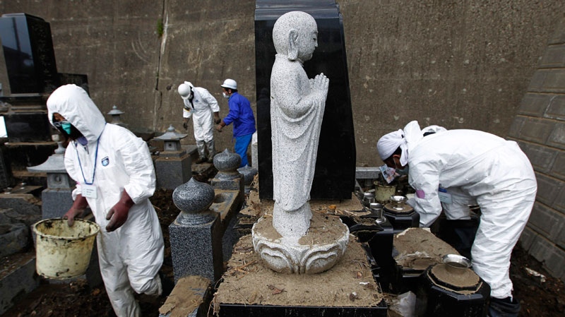 Volunteers help clean a cemetery at Jionin temple in Ishinomaki, Miyagi Prefecture, northeastern Japan, Friday, April 29, 2011. (AP / Hiro Komae)