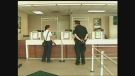 Police investigate after a reported robbery at a TD Canada Trust branch in London, Ont. on Friday, July 19, 2013.