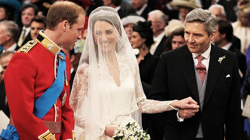 Prince William greets Kate Middleton as she arrives at the alter with her father Michael Middleton, prior to their marriage in London's Westminster Abbey, Friday April 29 2011. (AP / Dominic Lipinsk)