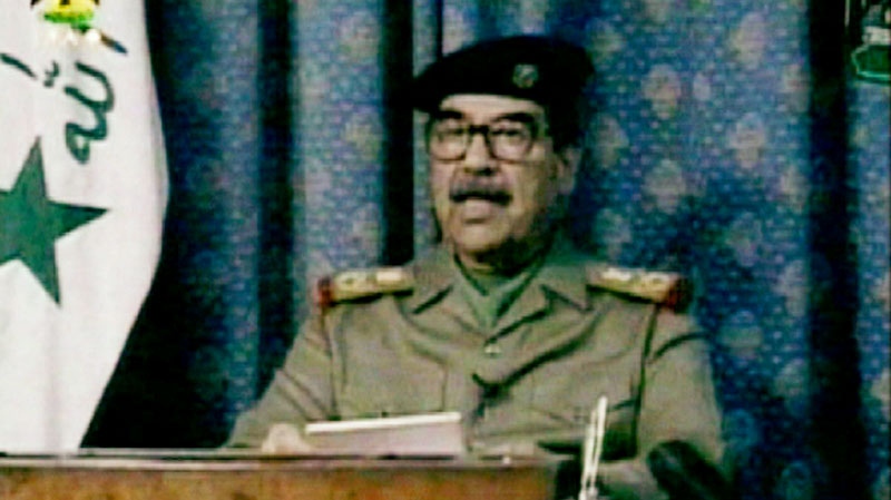Iraqi President Saddam Hussein speaks during a nationally televised address shown on Iraqi television on March 20, 2003. (AP / Iraqi TV via APTN)