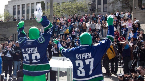 The Green Men, seen wearing Vancouver Canucks jersey's, attend an event at Vancouver City Hall after the mayor declared Tuesday, April 27, 2010 Canucks Day. (THE CANADIAN PRESS/Jonathan Hayward)
