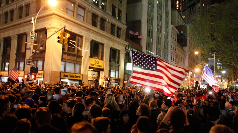  A large, jubilant crowd reacts to the news of Osama Bin Laden's death at the corner of Church and Vesey Streets, adjacent to ground zero, during the early morning hours in New York on Tuesday, May 2, 2011. (AP / Jason DeCrow)