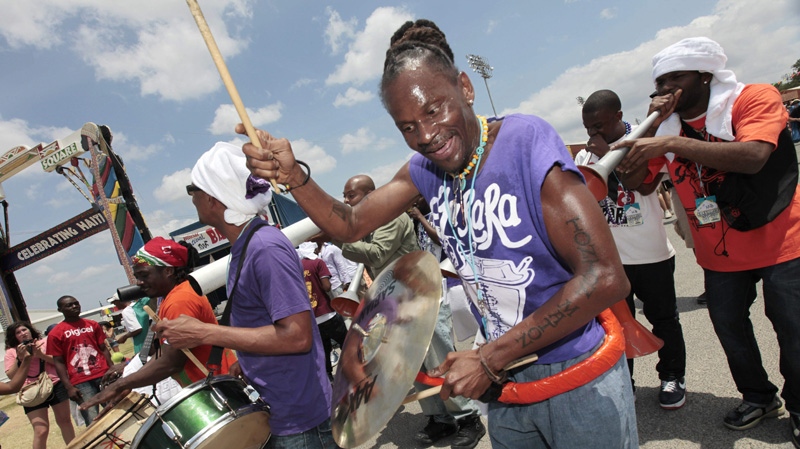 Members of the Haitian band DJA-Rara perform as they march through the fairgrounds at the Louisiana Jazz and Heritage Festival in New Orleans, Sunday, May 1, 2011.