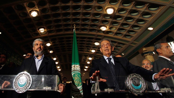 The Damascus-based leader of Hamas Khaled Mashaal, left, and Arab League chief Amr Moussa, right, speak to the media during a press conference at the Arab League headquarters in Cairo, Egypt, Tuesday, May 3, 2011.(AP / Khalil Hamra)