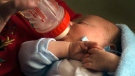 An infant drinks from a bottle in this 2011 file photo. (AP Photo/James B. Hale)