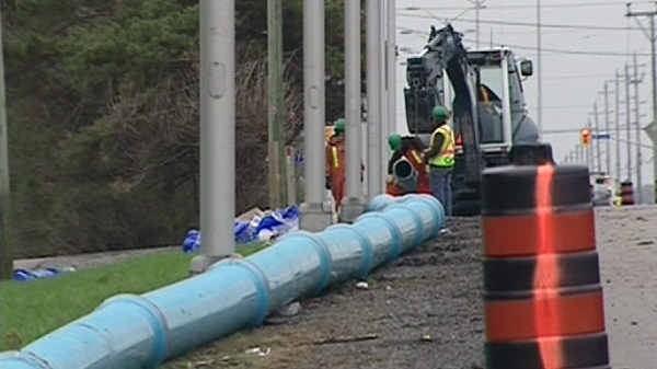 Crews get to work on replacing a problem water main on Woodroffe Avenue, Tuesday, May 3, 2011.