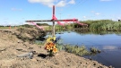 The father of 15-year-old Tarren Attfield, Dalbert, placed a wooden cross at the scene of a tragic collision that took the life of his son and five other teens. 