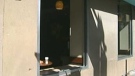 An empty window where the glass was smashed is seen at Starbucks in London, Ont. on Tuesday, July 30, 2013.