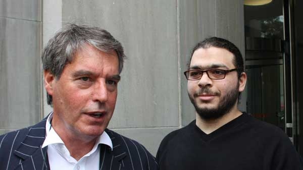 Abdullah Khadr (right) looks on as his lawyer Dennis Edney talks to media outside court in Toronto, Wednesday, Aug.4, 2010.