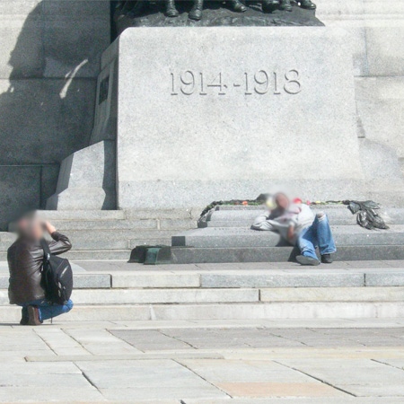 This person poses for a photo while sitting on the Tomb of the Unknown Soldier, in Ottawa.