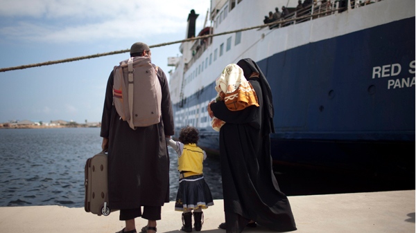A family fleeing from the fighting in the besieged Libyan city of Misrata looks at the ship that transported them after arriving in Benghazi, Libya, Thursday, May 5, 2011. (AP / Rodrigo Abd)