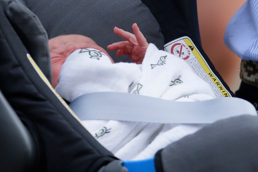 Prince George shown in bird-print swaddle